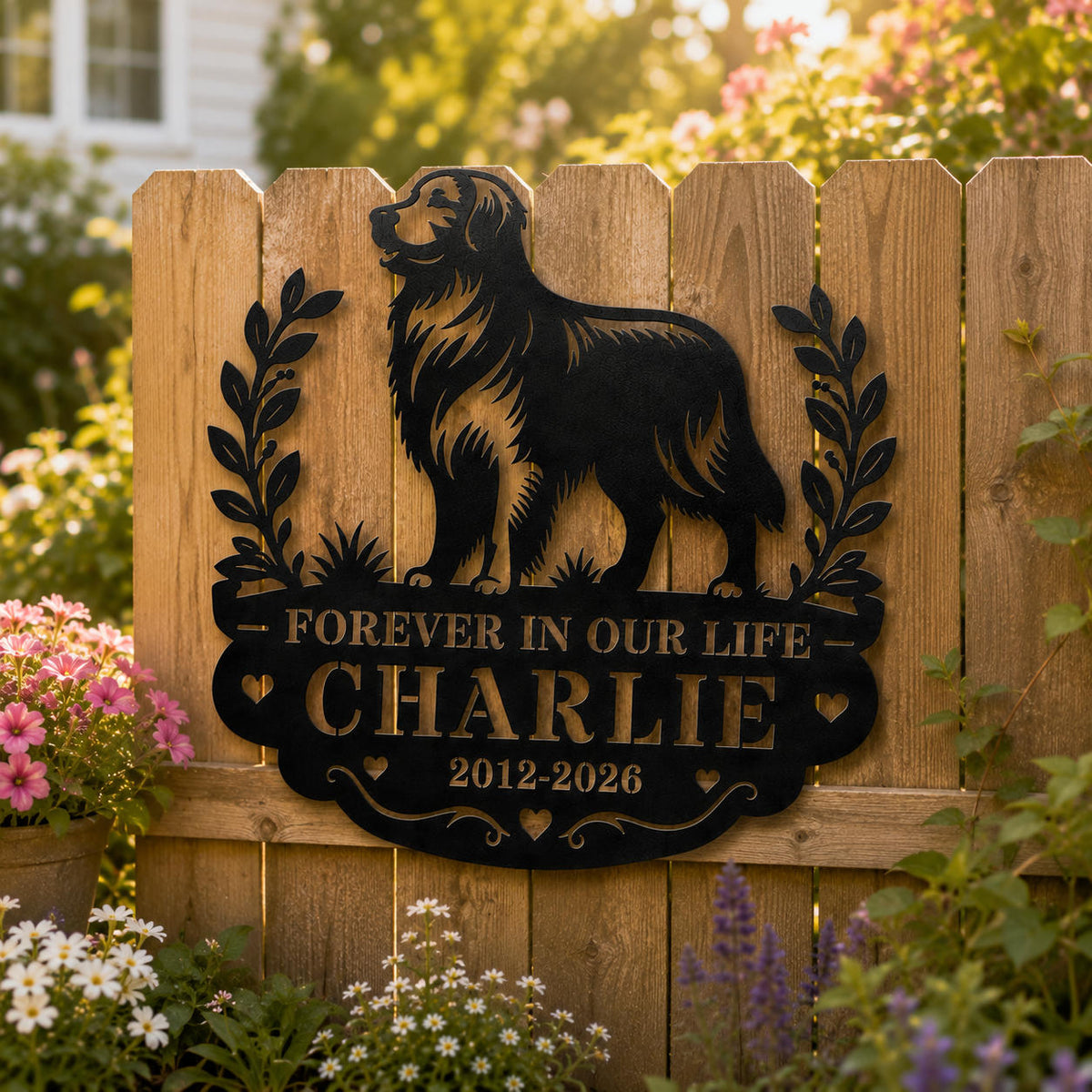Black personalized dog memorial metal sign mounted on a wooden garden fence in a backyard setting.