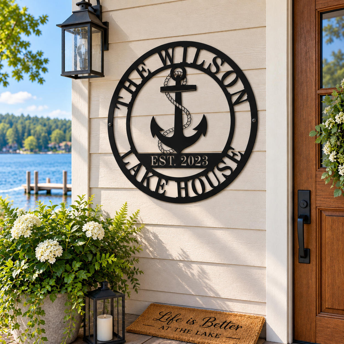 Custom black metal lake house sign with anchor displayed at a lakeside home entrance.