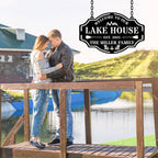 Custom metal lake house sign with family name, trees, paddles, and chairs design, black powder-coated steel, personalized outdoor cabin wall decor.