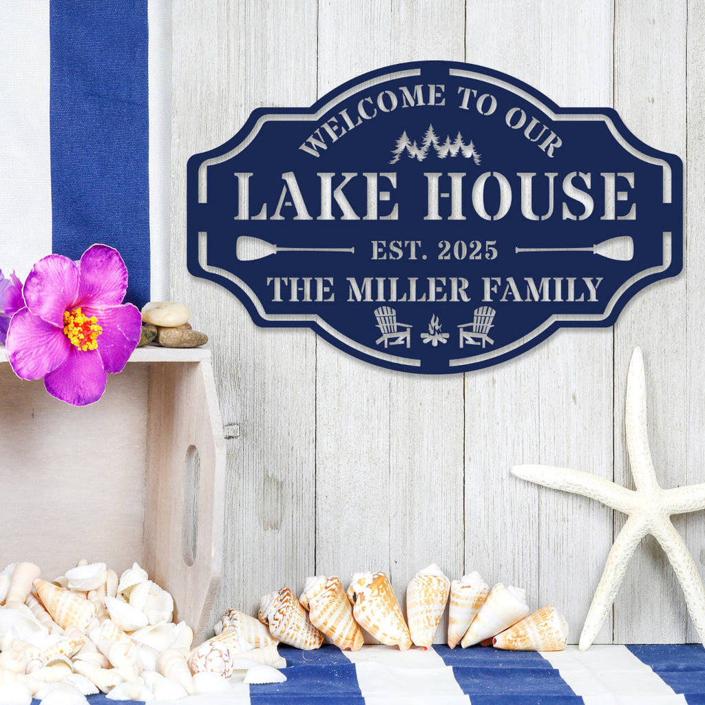 Custom metal lake house sign with family name, trees, paddles, and chairs design, black powder-coated steel, personalized outdoor cabin wall decor.
