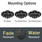 Custom metal lake house sign with family name, trees, paddles, and chairs design, black powder-coated steel, personalized outdoor cabin wall decor.