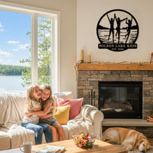 Custom lake kids metal sign featuring children silhouette design, personalized family name and year, round steel wall decor for lake house or cabin