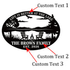 Black laser-cut steel oval lake sign reading "Life is Better at the Lake" with soaring eagle, lake scene, Adirondack chairs, campfire, and pine trees, personalized with "The Brown Family" and EST 2026 — custom lake house metal wall art