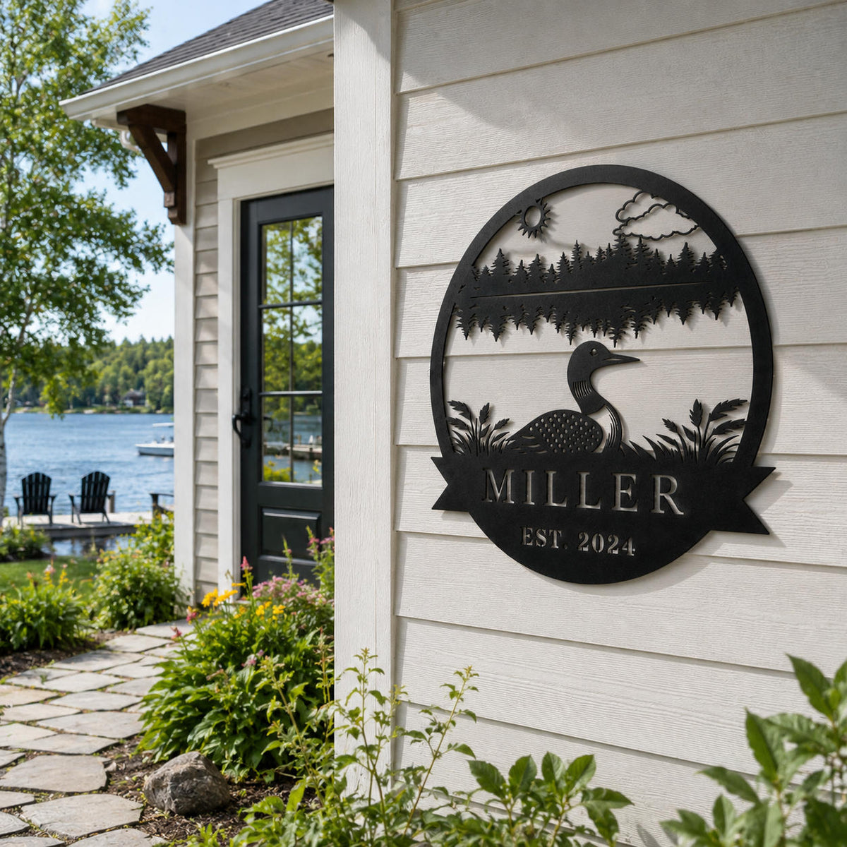 Custom Miller loon lake house metal sign displayed on an exterior wall beside a peaceful lakeside home.