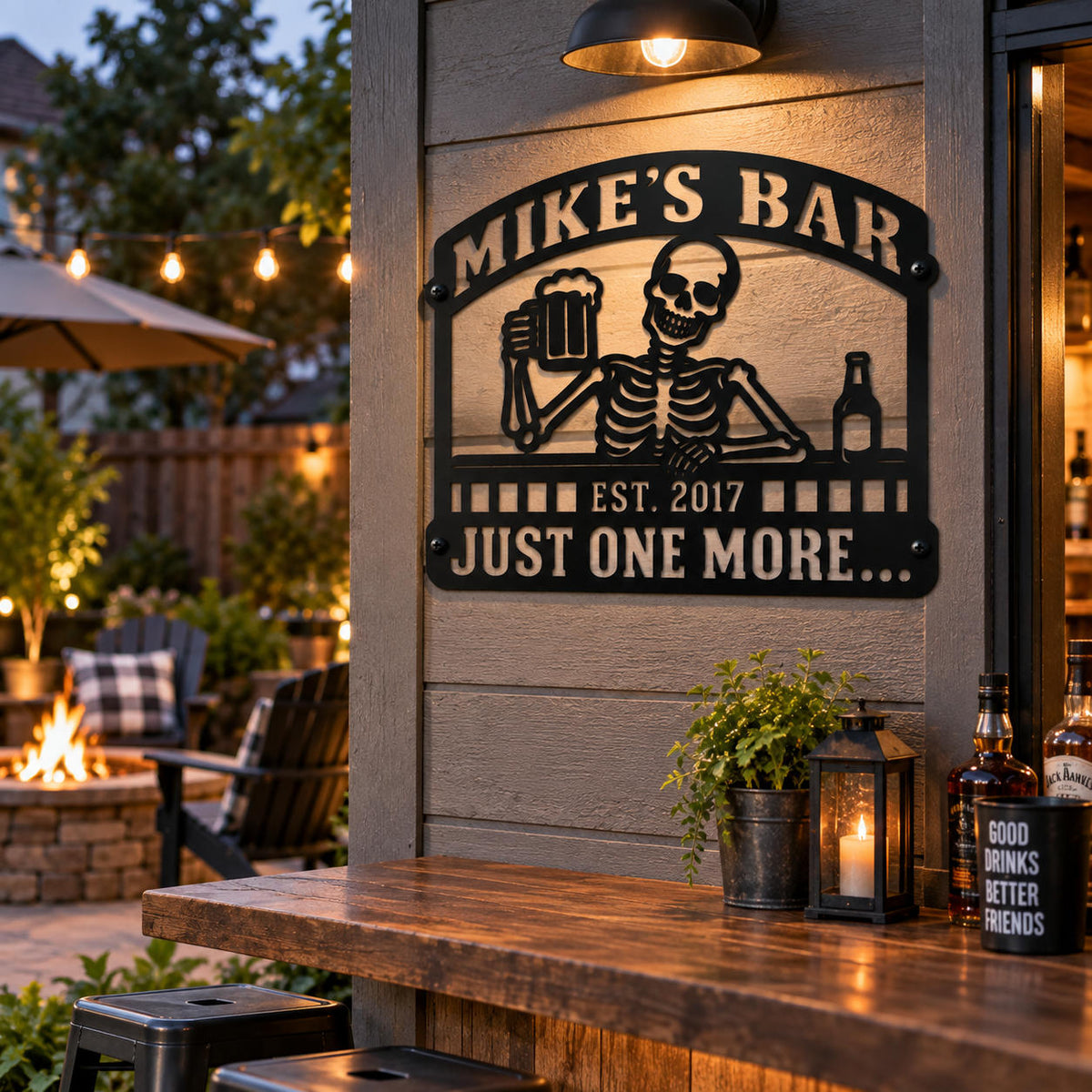 Custom black metal bar sign with skeleton and beer design displayed in a cozy backyard patio bar setting.