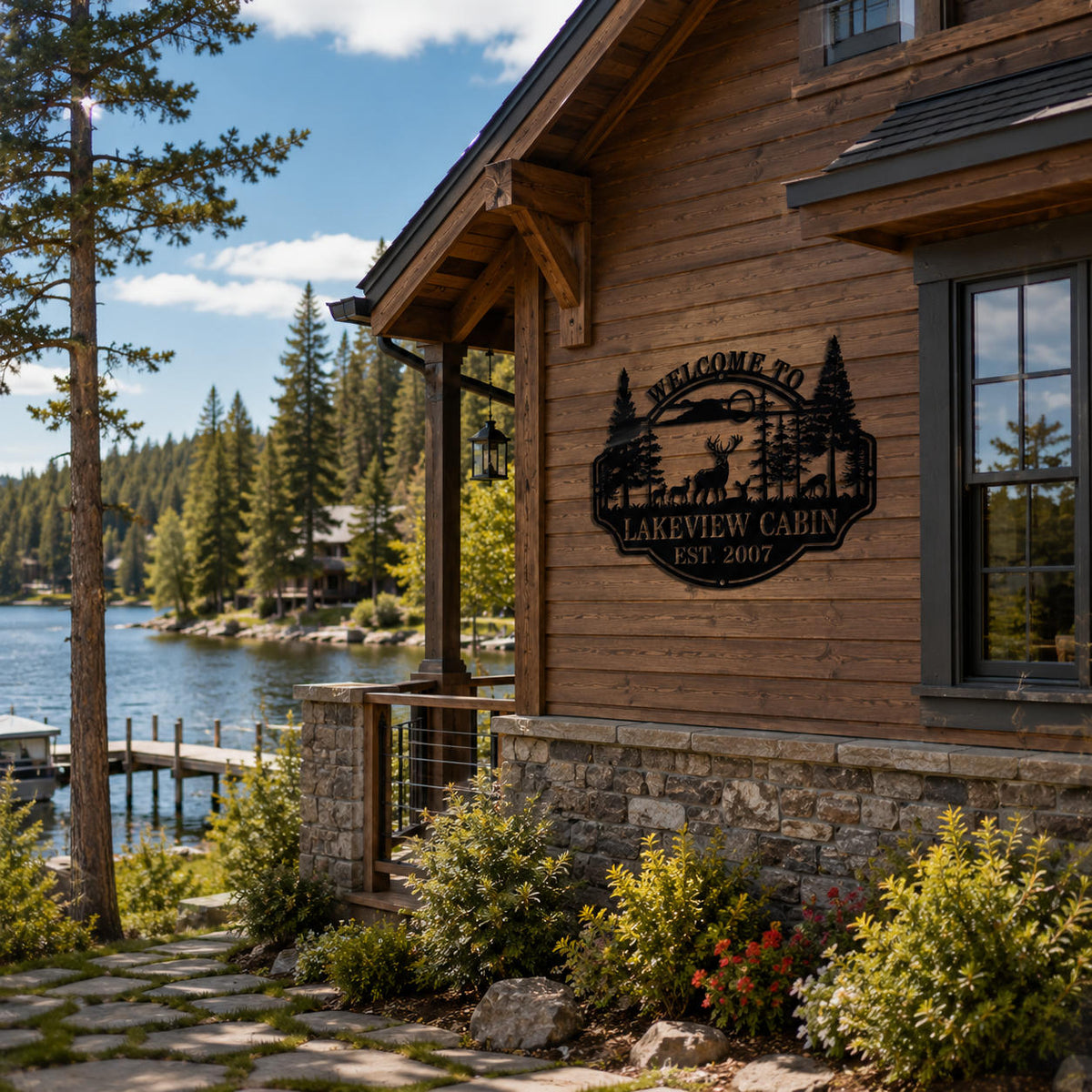 Personalized lake house metal sign with deer and forest design displayed on lakeside cabin exterior wall, custom outdoor metal decor