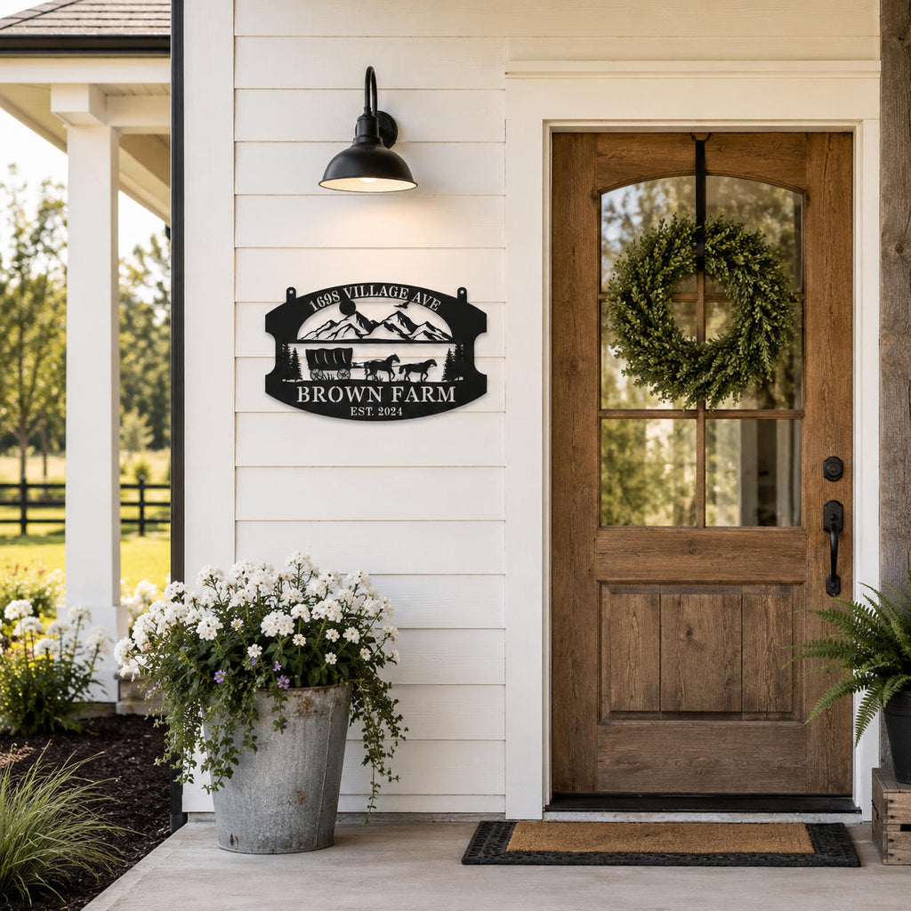 Personalized metal farm sign mounted on the exterior wall of a modern farmhouse entrance.
