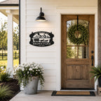 Personalized metal farm sign mounted on the exterior wall of a modern farmhouse entrance.