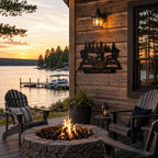 Custom metal campfire family name sign displayed on a lake house patio overlooking the water at sunset.