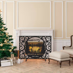 Custom laser-cut metal fireplace screen with personalized family name and lakehouse cabin design in front of a burning fireplace.