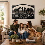 Custom family ranch sign displayed in front of a farmhouse with a couple standing nearby