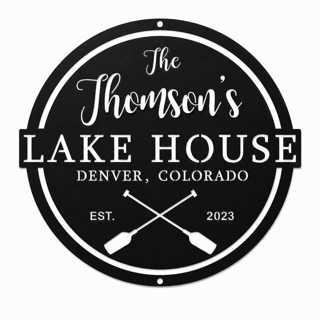 Personalized black metal lake house sign with family name, location, established year, and crossed paddle design on a white background.