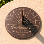 Custom metal sundial displayed outdoors in natural sunlight, showing the working shadow cast by the sundial gnomon.