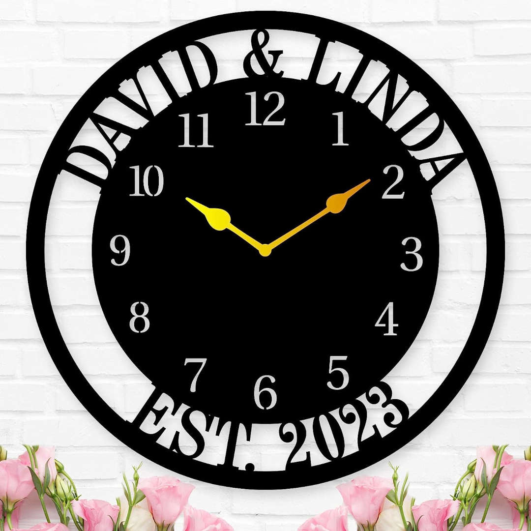 Large personalized black metal wall clock with a solid center dial, featuring laser-cut cutout family names, established 2023, and modern Arabic numbers.
