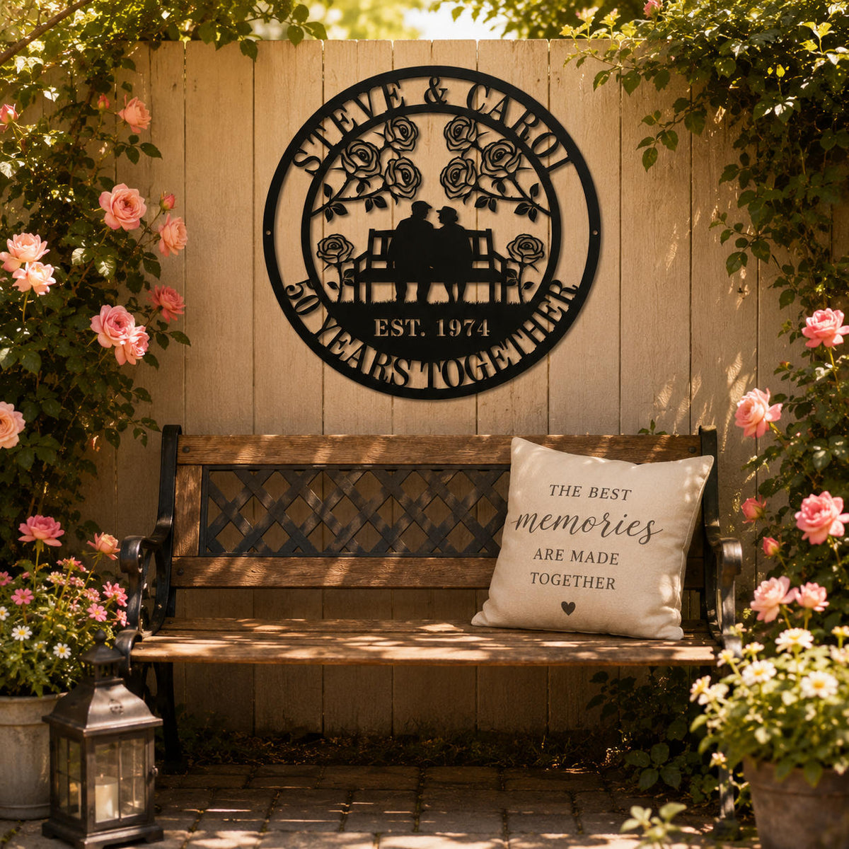 Custom anniversary metal sign installed above a garden bench surrounded by roses, personalized outdoor wall art celebrating lasting love