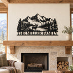 Black mountain and deer family sign displayed above a rustic wood mantel and stone fireplace.