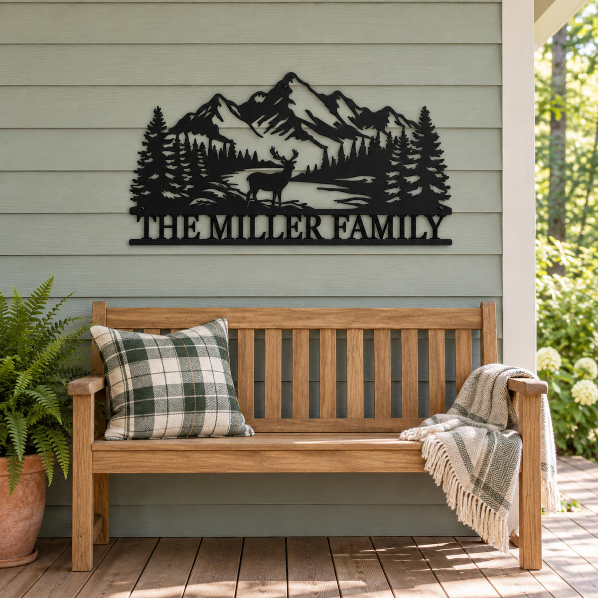 Personalized family metal sign on sage-gray porch siding above a wooden bench with a plaid cushion.