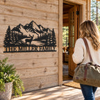 Custom family metal sign beside a woodland cabin doorway as a woman arrives carrying a weekend bag.