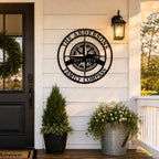 Custom compass metal wall sign with family name displayed on modern farmhouse porch exterior