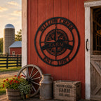 Custom farm compass metal sign displayed on rustic red barn exterior wall
