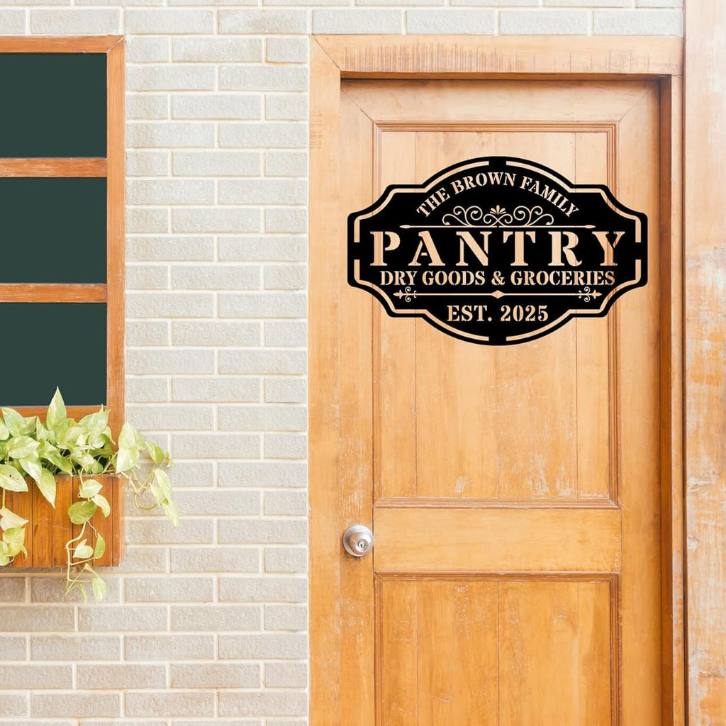 Custom black steel pantry sign with personalized text "The Brown Family Pantry Dry Goods & Groceries EST. 2025" with decorative vintage style