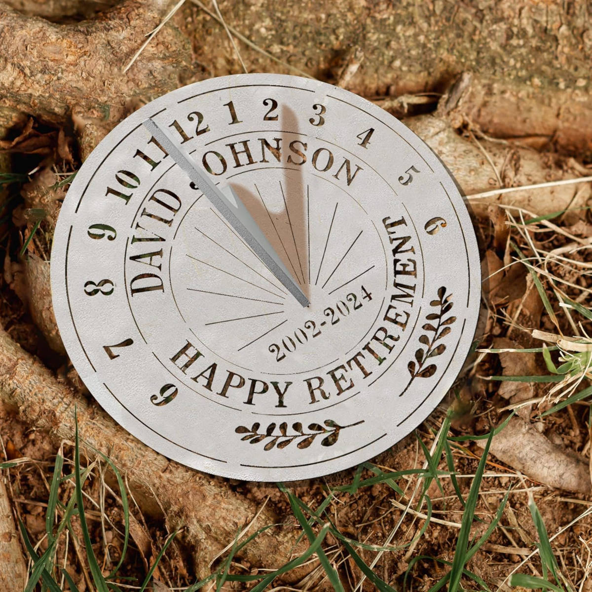 Personalized silver metal sundial with custom text "DAVID JOHNSON HAPPY RETIREMENT 2002-2024" and a central gnomon, designed for outdoor garden decoration.