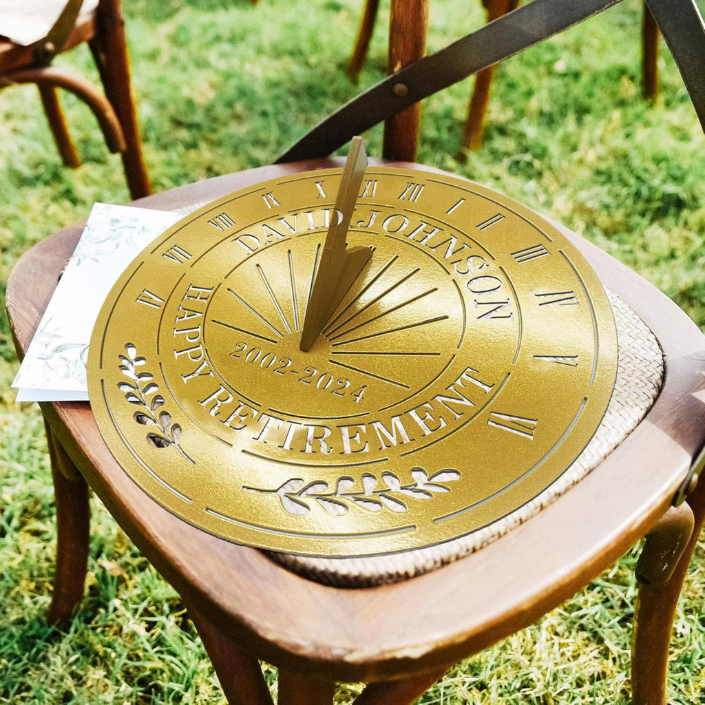 Personalized gold metal sundial with custom text "DAVID JOHNSON HAPPY RETIREMENT 2002-2024" and a central gnomon, designed for outdoor garden decoration.