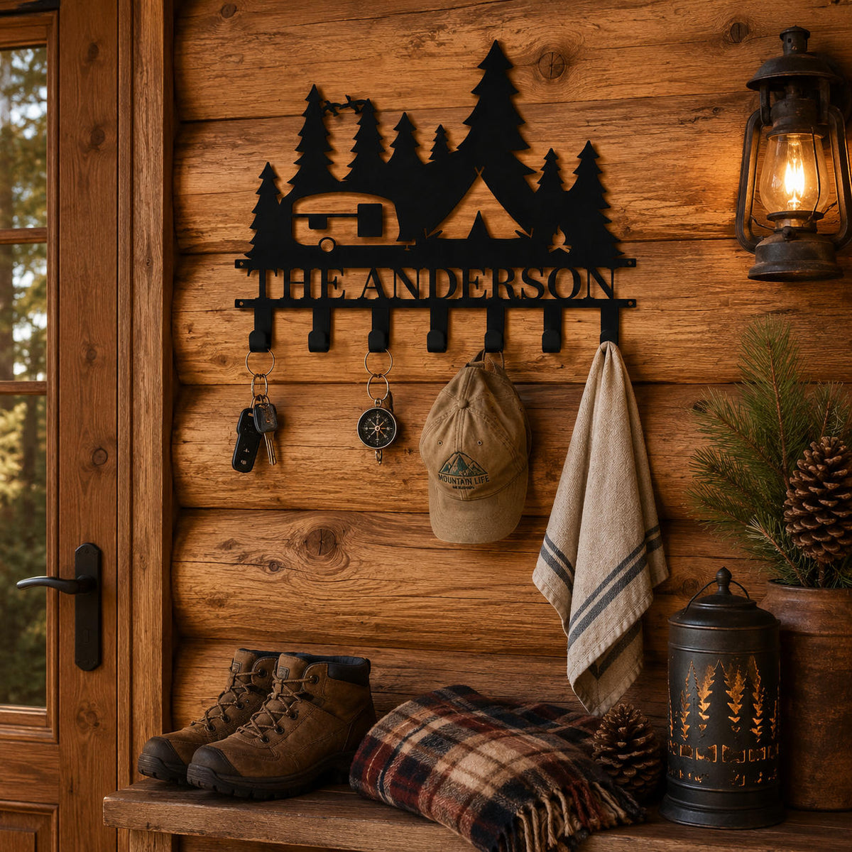 Custom RV camping key holder displayed on a rustic cabin wall with keys, a cap, and a lightweight towel.