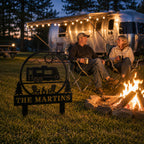 Personalized RV campsite metal sign displayed beside a campfire with family enjoying outdoor camping