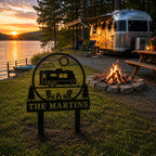Personalized RV camping yard sign displayed near a lakeside camper site during sunset