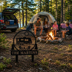 Custom metal RV campsite sign with family name at a campsite entrance with camper and outdoor activities