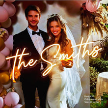 Custom script neon sign glowing in warm amber light with personalized text, decorative LED neon sign for bedroom and home décor, customizable font size and color