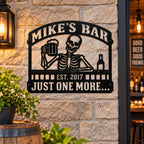 Custom skeleton bar metal sign mounted on a stone wall with four black screws beside a rustic home bar entrance.