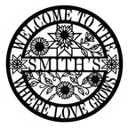 Custom round metal family name sign featuring laser-cut sunflowers and "Where Love Grows" text.