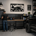 Personalized truck zone metal sign displayed inside a professional garage workshop with pickup truck and tool storage.