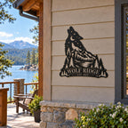 Personalized wolf metal sign mounted on a lakeside cabin wall overlooking a mountain lake.