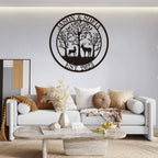 Customizable round black metal sign with a laser-cut design featuring a buck and a doe in a forest of trees. The top text reads "JASON & SOFIA" and the bottom text reads "EST. 2023".