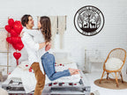 Customizable round black metal sign with a laser-cut design featuring a buck and a doe in a forest of trees. The top text reads "JASON & SOFIA" and the bottom text reads "EST. 2023".