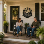 Custom deer mountain family name metal sign displayed on a welcoming front porch with homeowners relaxing nearby.