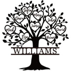 A black metal sign with a tree design and personalized text in the form of heart-shaped leaves and the family name at the base.