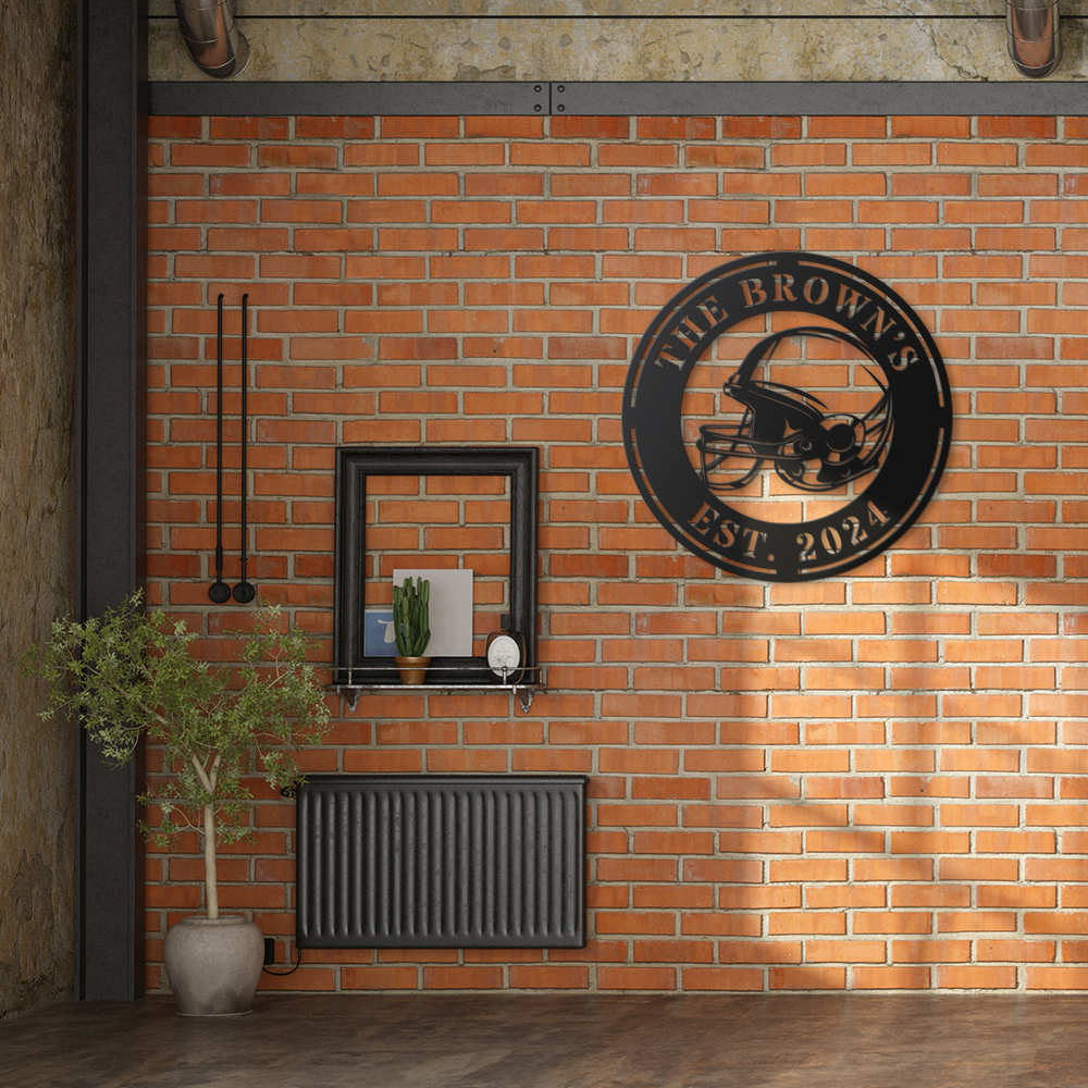 Black metal football helmet sign with personalized text "THE BROWN'S EST. 2024", laser-cut from steel and powder-coated, perfect for sports-themed home decor.