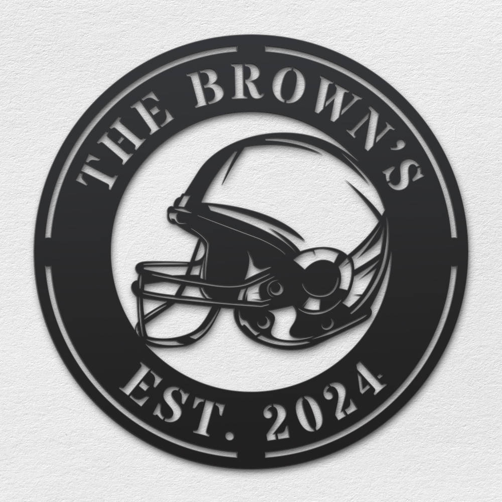 Black metal football helmet sign with personalized text "THE BROWN'S EST. 2024", laser-cut from steel and powder-coated, perfect for sports-themed home decor. Main image