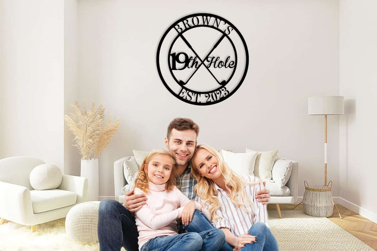 Round custom metal golf sign featuring crossed golf clubs and "19th Hole" text, personalized with name and established year, made from durable powder-coated steel.