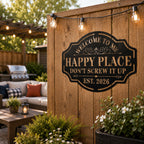 Personalized Happy Place metal sign displayed on a backyard patio fence with string lights and outdoor seating.