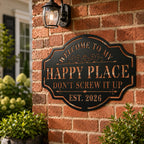 Custom black metal Happy Place sign installed on a red brick exterior wall, personalized outdoor welcome decor.