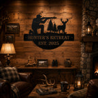 Hunter's Retreat metal wall sign displayed in a rustic hunting lodge interior with wood walls and fireplace