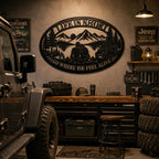 Oval adventure metal wall sign displayed inside a modern off-road garage.