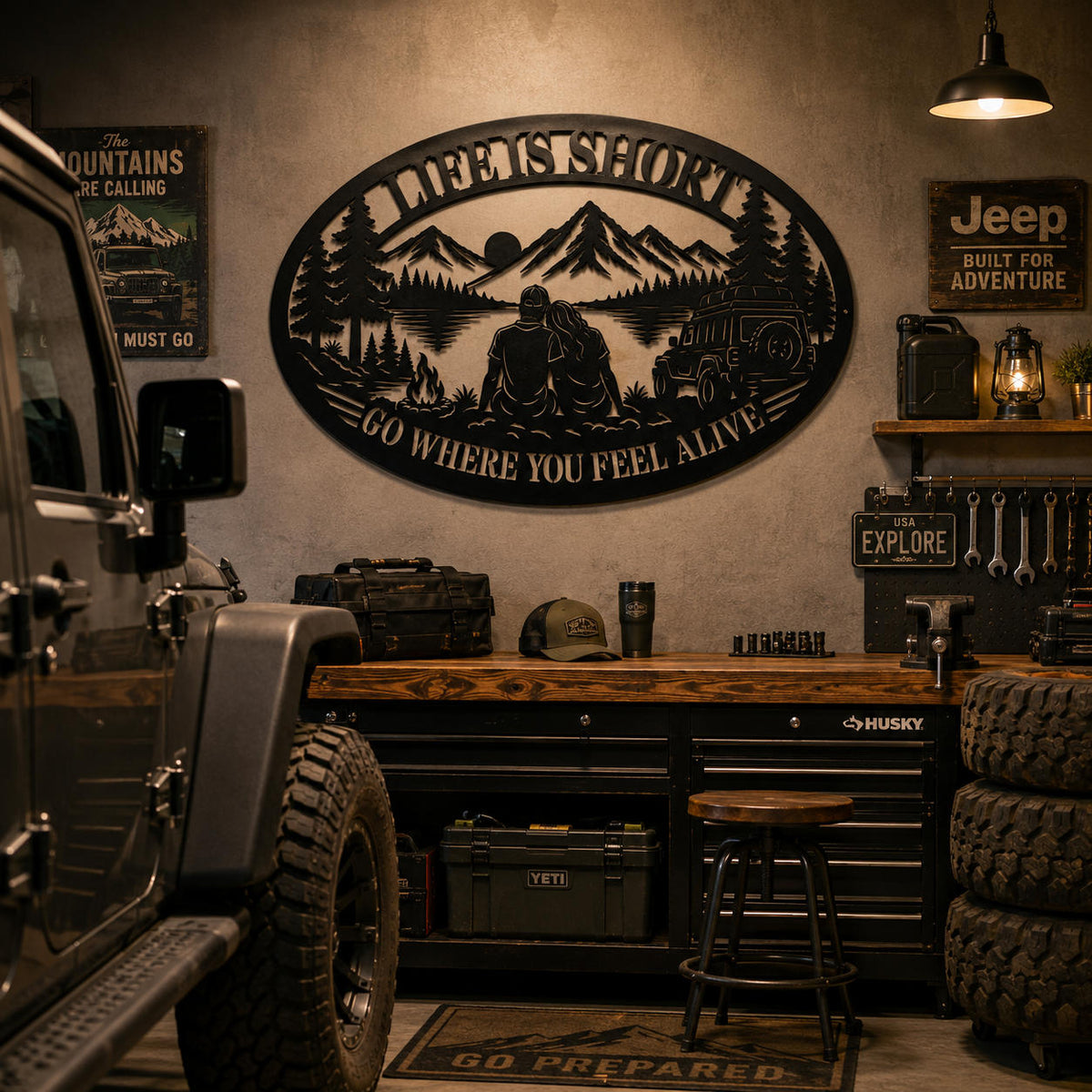 Oval adventure metal wall sign displayed inside a modern off-road garage.