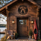 Round metal wall sign mounted above the entrance of a rustic lakeside cabin, adding personalized outdoor decor to a cozy wooden retreat.
