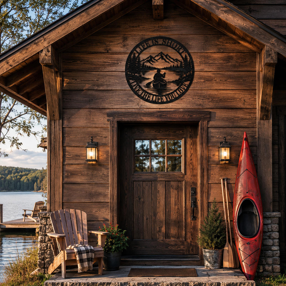 Round metal wall sign mounted above the entrance of a rustic lakeside cabin, adding personalized outdoor decor to a cozy wooden retreat.